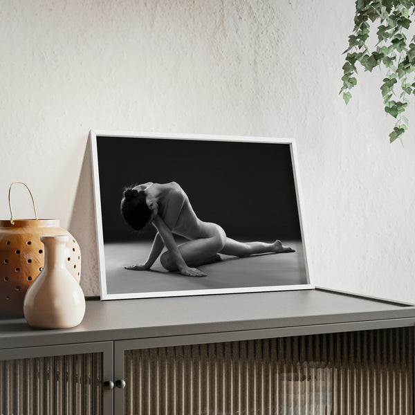 Nude woman doing yoga pose in black and white in white frame on a shelf in a living room