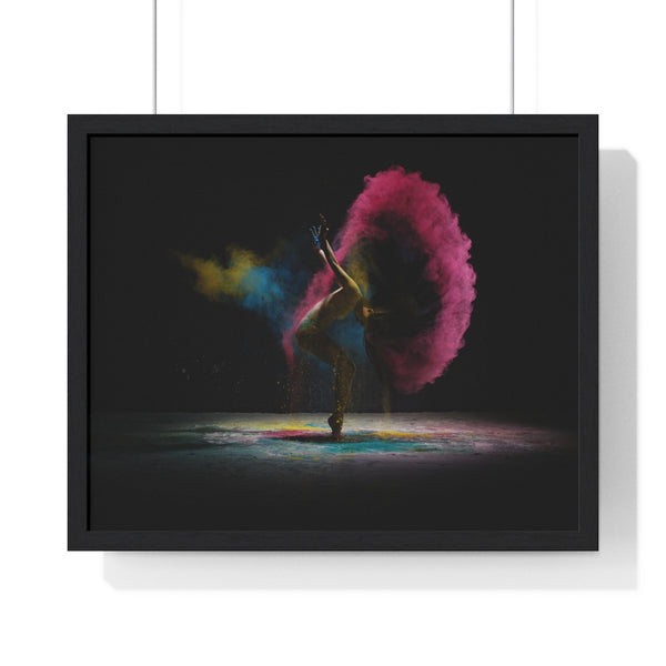 Female dancer performing a contemporary dance movement in a set with colorful dust radiating from her movement