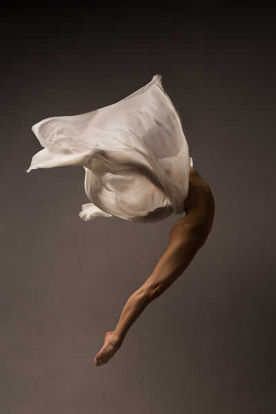 Ballerina, jump, body arch, face covered by white airy fabric.. Photo print studio, in colors, nude bodysuit.
